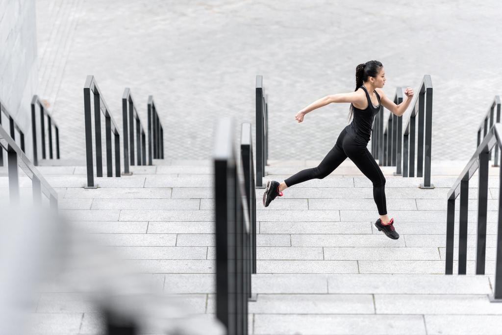 Sportswoman training on stadium stairs  - Photo, Image
