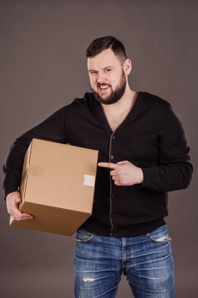 handsome male carrying box moving into new work place - Photo, Image