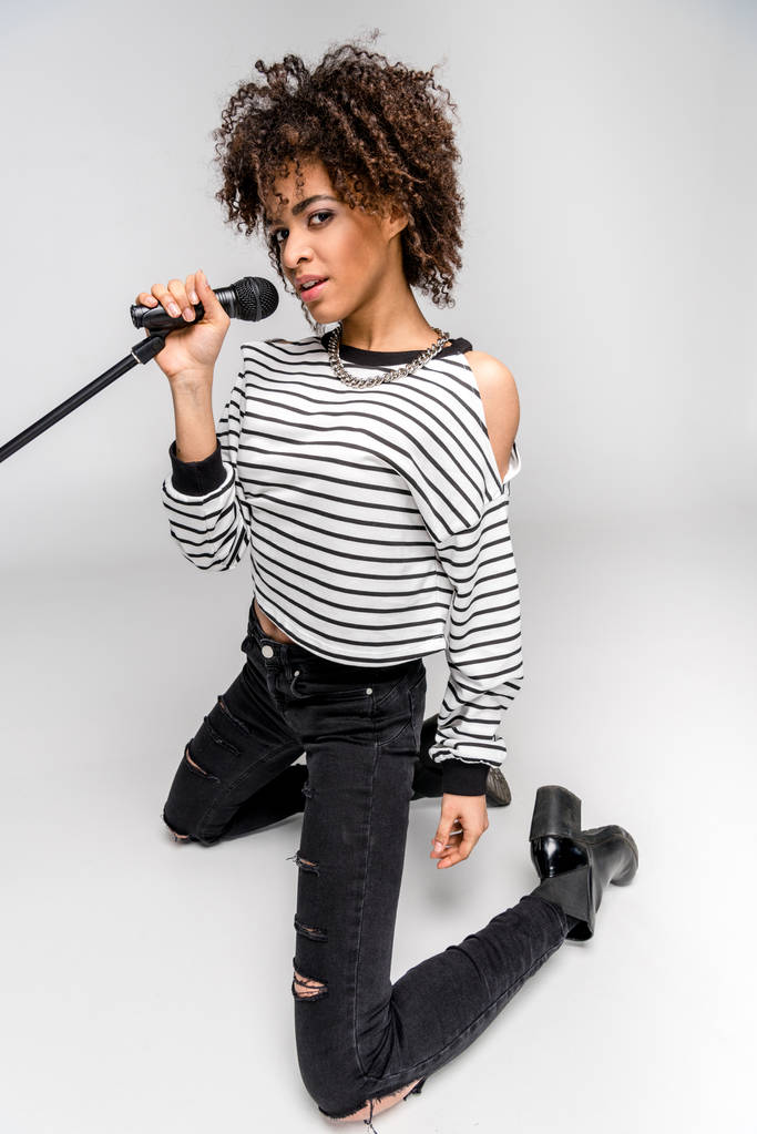 fiatal énekes mikrofonnal  - Fotó, kép