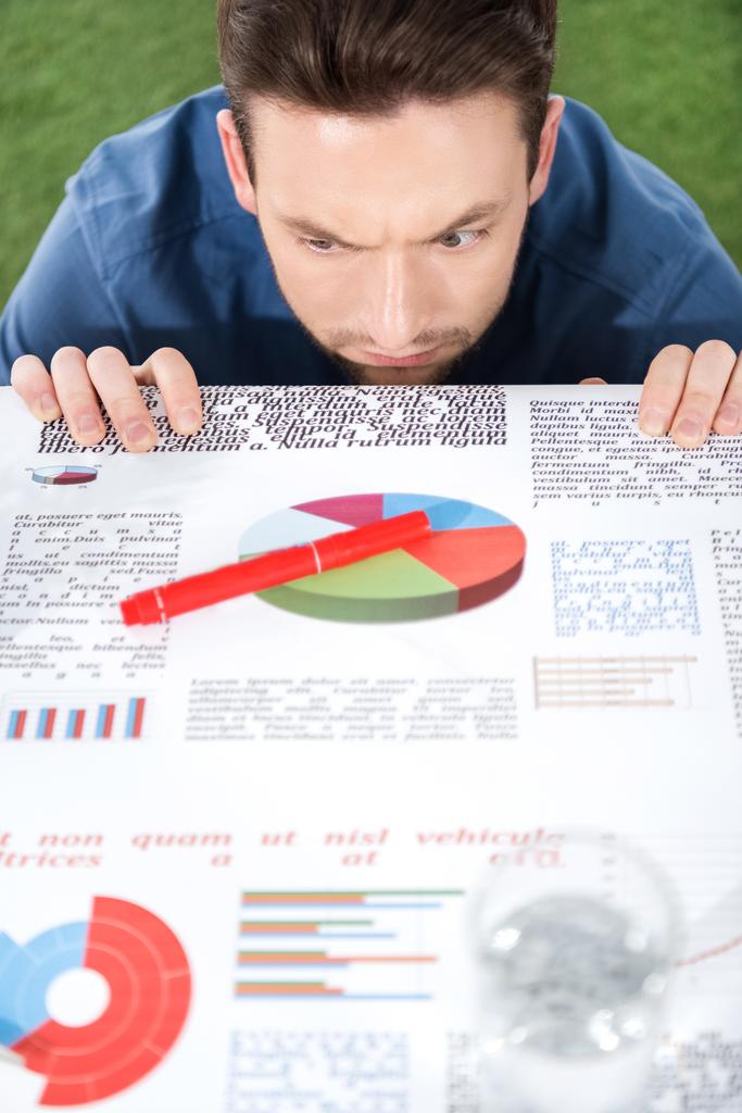 businessman looking at documents with charts and diagrams - Photo, Image