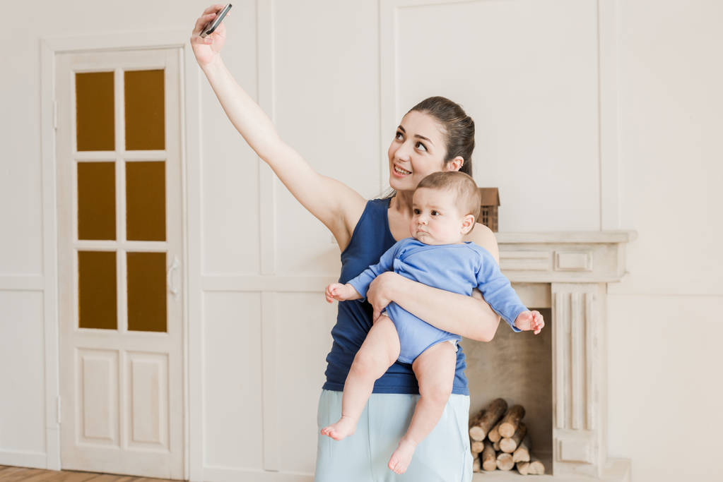 Smiling mother with son taking selfie  - Photo, Image