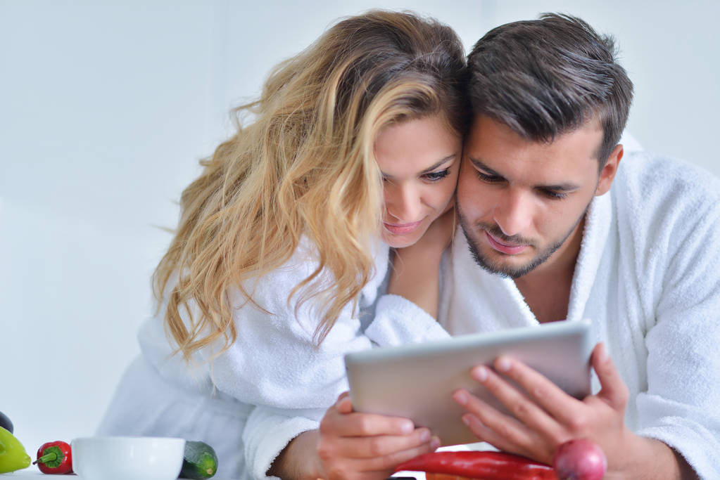 couple utilisant une tablette dans la cuisine
 - Photo, image