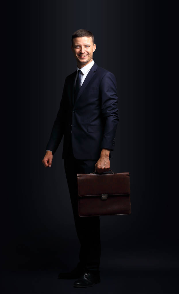 Portrait of a handsome business man  with briefcase isolated on - Photo, Image