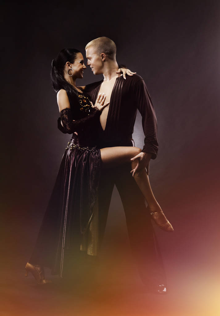 Jeune couple dansant sur fond noir
. - Photo, image