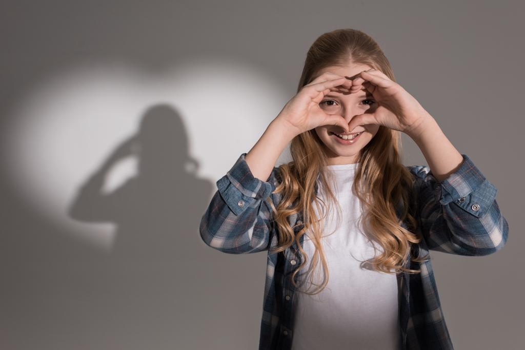 girl with heart shaped shadow - Photo, Image