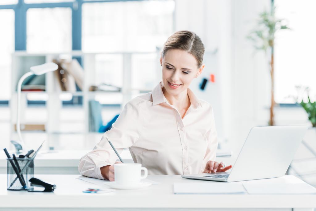 businesswoman working on laptop at office - Photo, Image