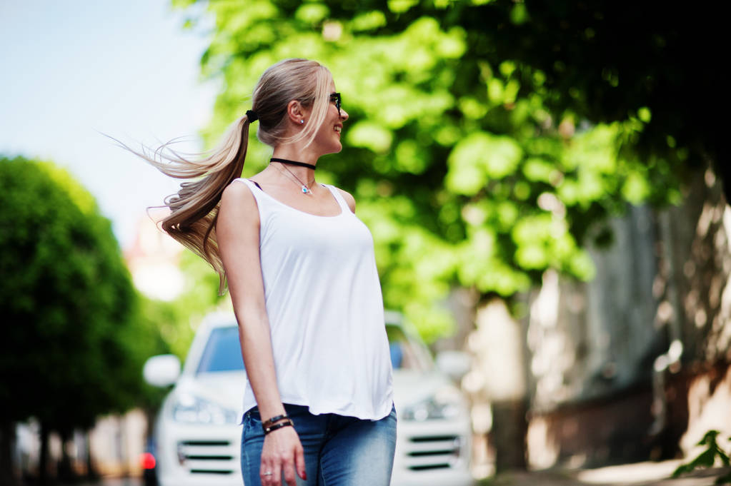 Stylish blonde woman wear at jeans, glasses, choker and white sh - Photo, Image
