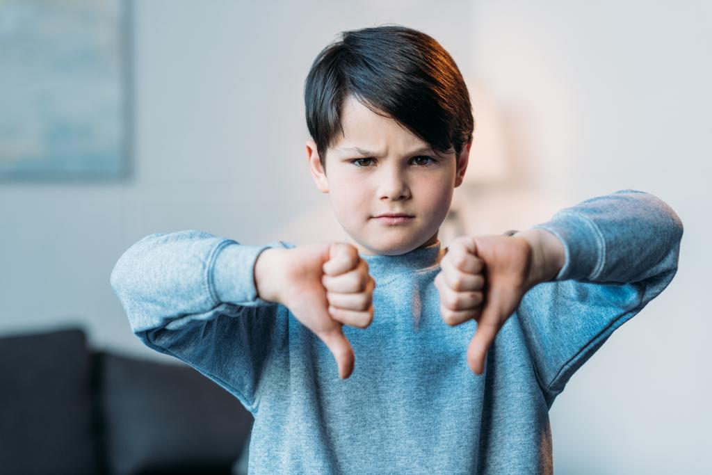 boy showing thumbs down - Photo, Image