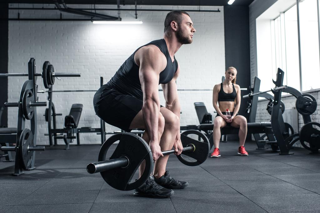 man doing strength training while woman sitting - Photo, Image