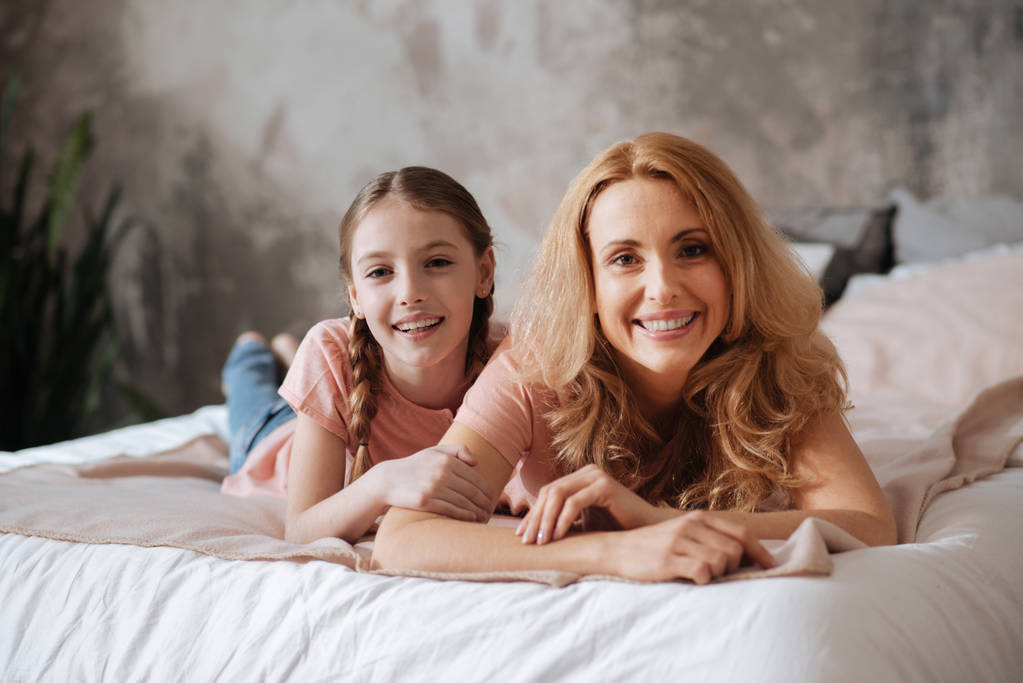 Joyful mother and little daughter relaxing at home - Photo, Image