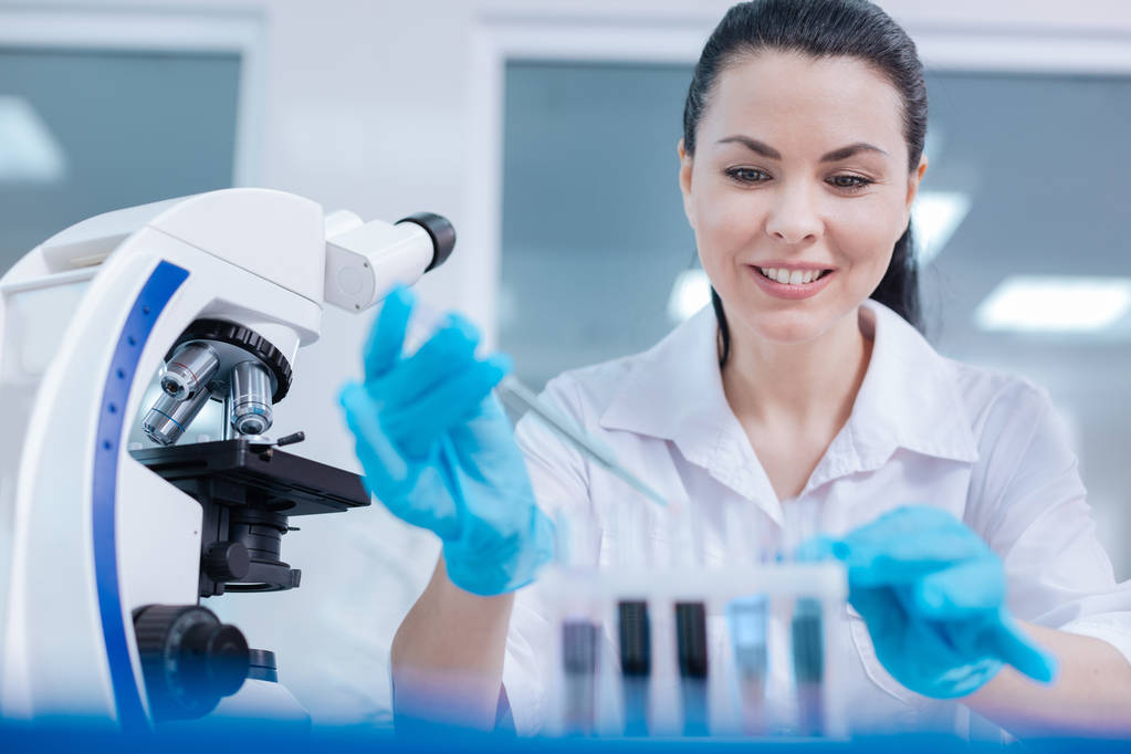 Smiling female scientist loving her job - Photo, Image