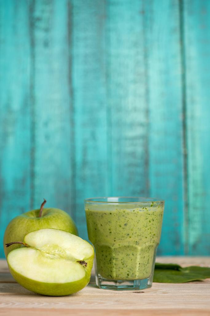 apples with smoothie in glass on wooden table - Photo, Image