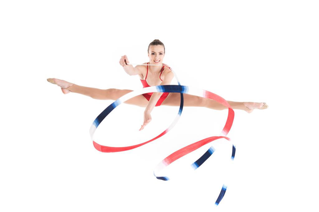 жінка ритмічна гімнастка стрибає з мотузкою
 - Фото, зображення