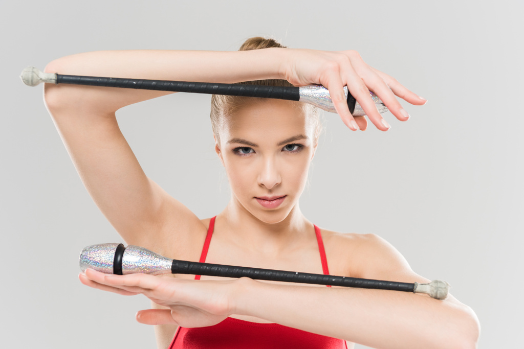 woman rhythmic gymnast exercising with clubs - Photo, Image