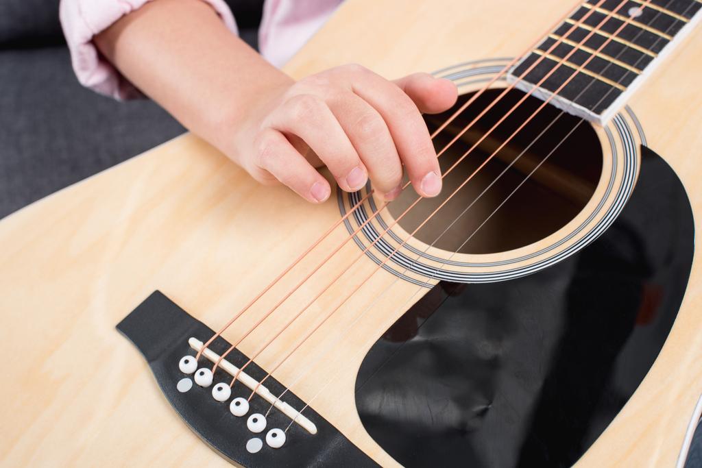 Девушка практикуется играть на гитаре
  - Фото, изображение