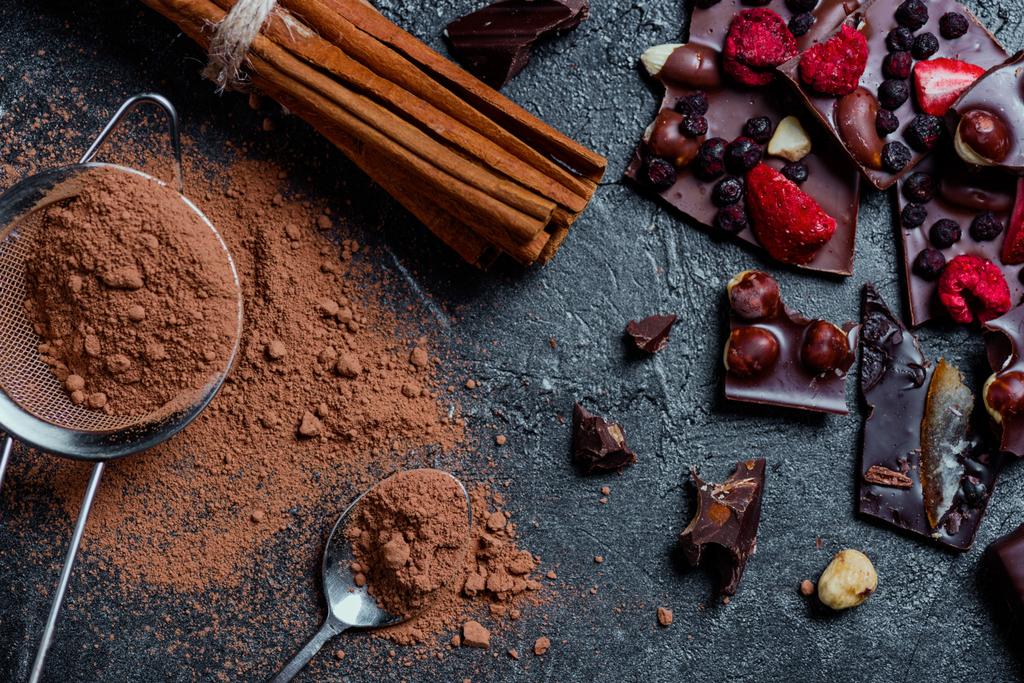 pieces of chocolate with nuts and berries with cinnamon - Photo, Image