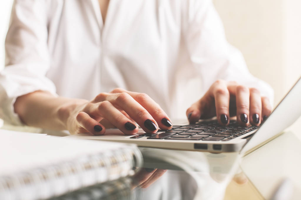 Woman typing on laptop keyboard - Photo, Image
