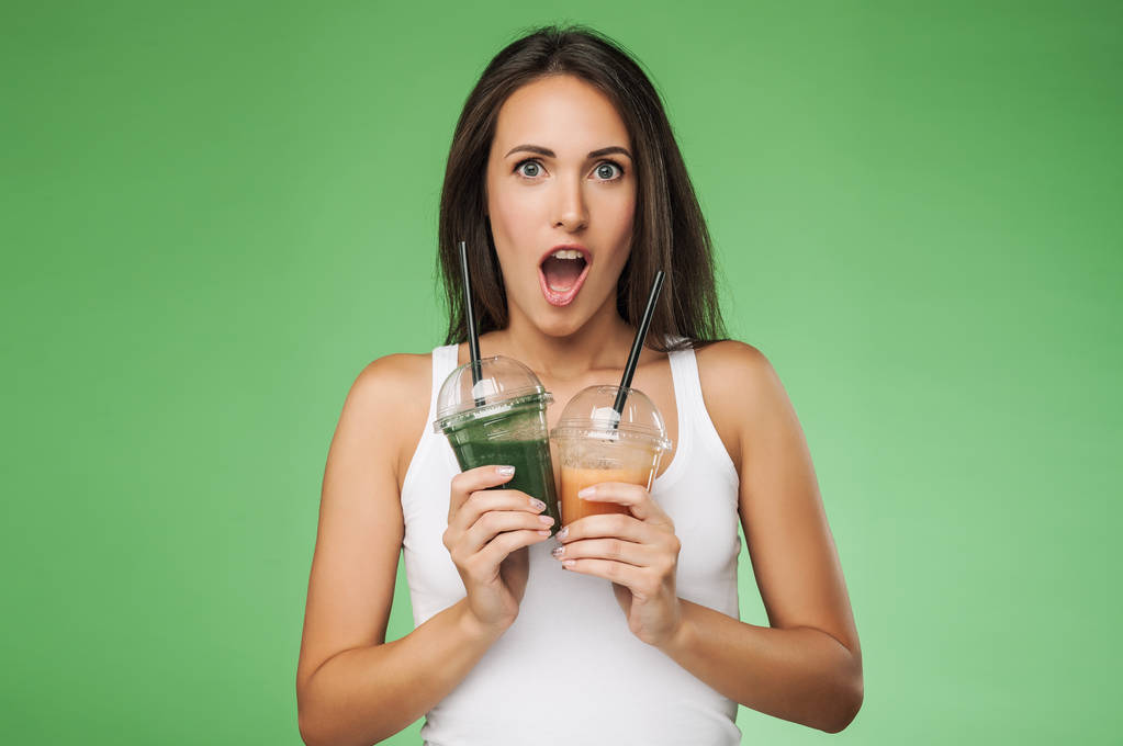 Young surprised woman holding smoothie - Photo, Image