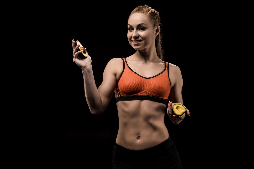 sporty girl holding avocado - Photo, Image