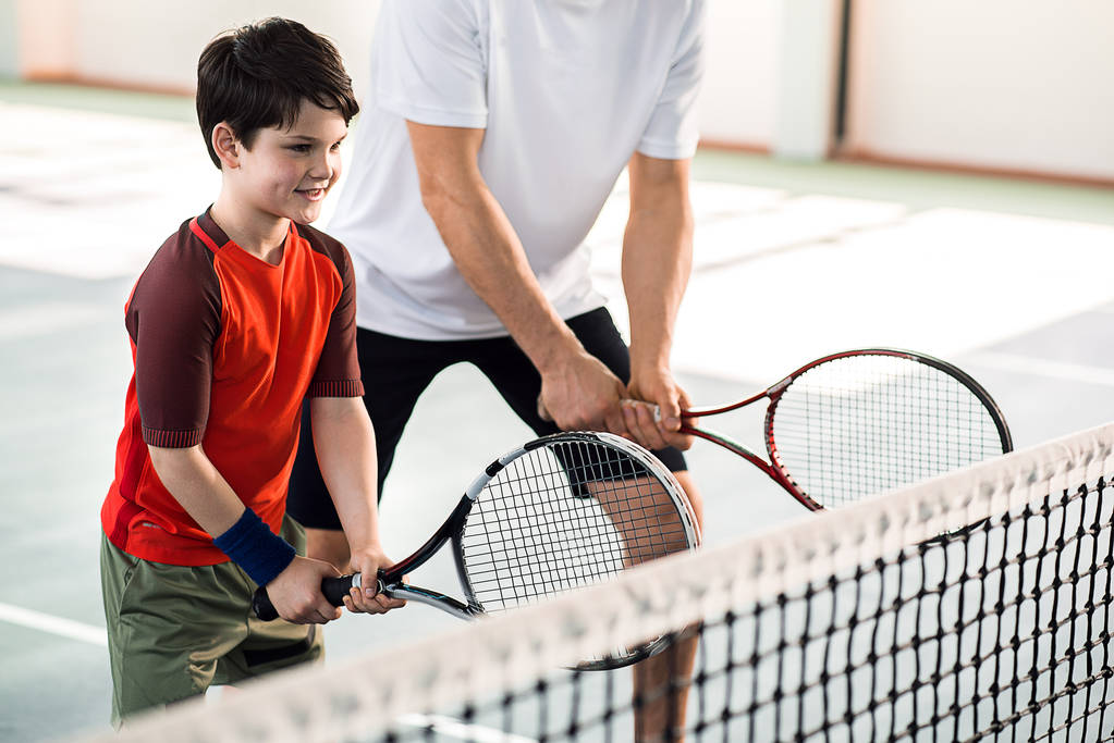 Joyful kid playing tennis with father - Photo, Image