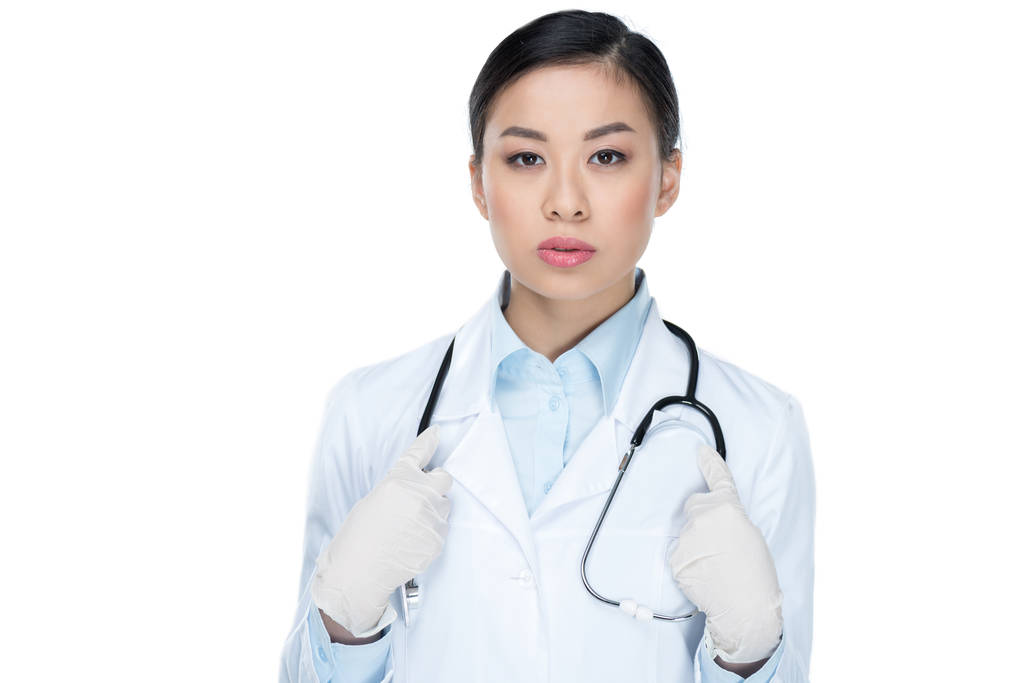 Arzt in Schutzhandschuhen mit Stethoskop - Foto, Bild