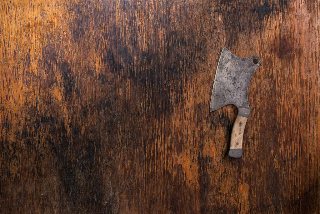 Vintage knife of butcher on old wooden background - Photo, Image