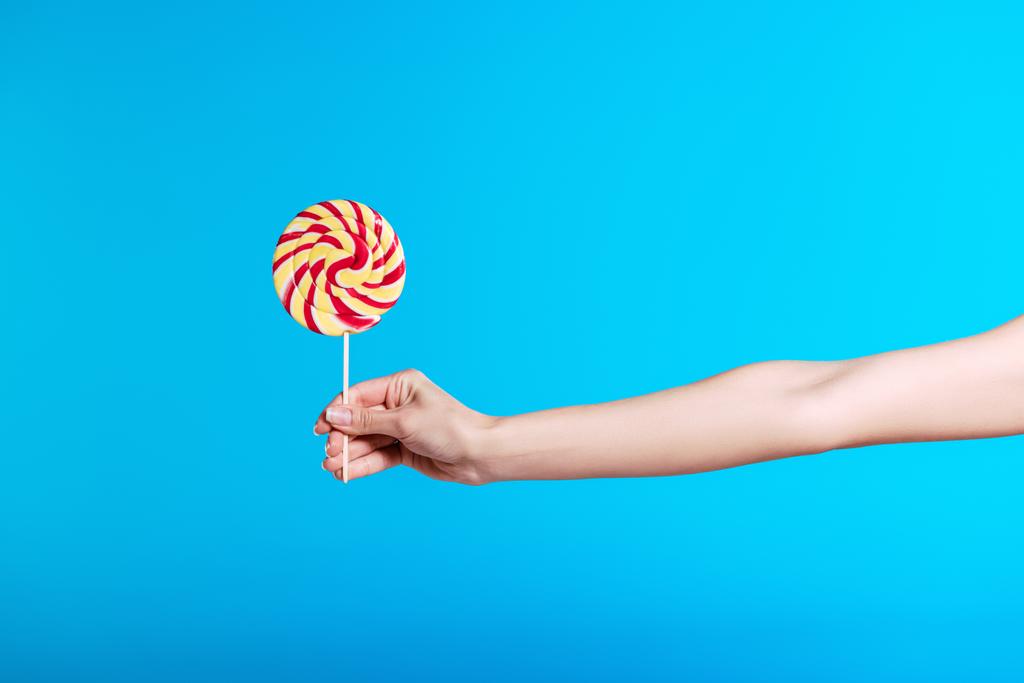 Hand holding lollipop  - Photo, Image
