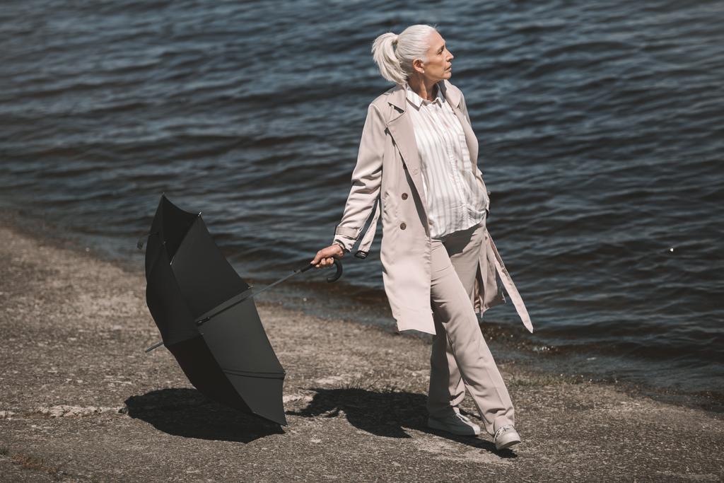 傘を持つ年配の女性  - 写真・画像
