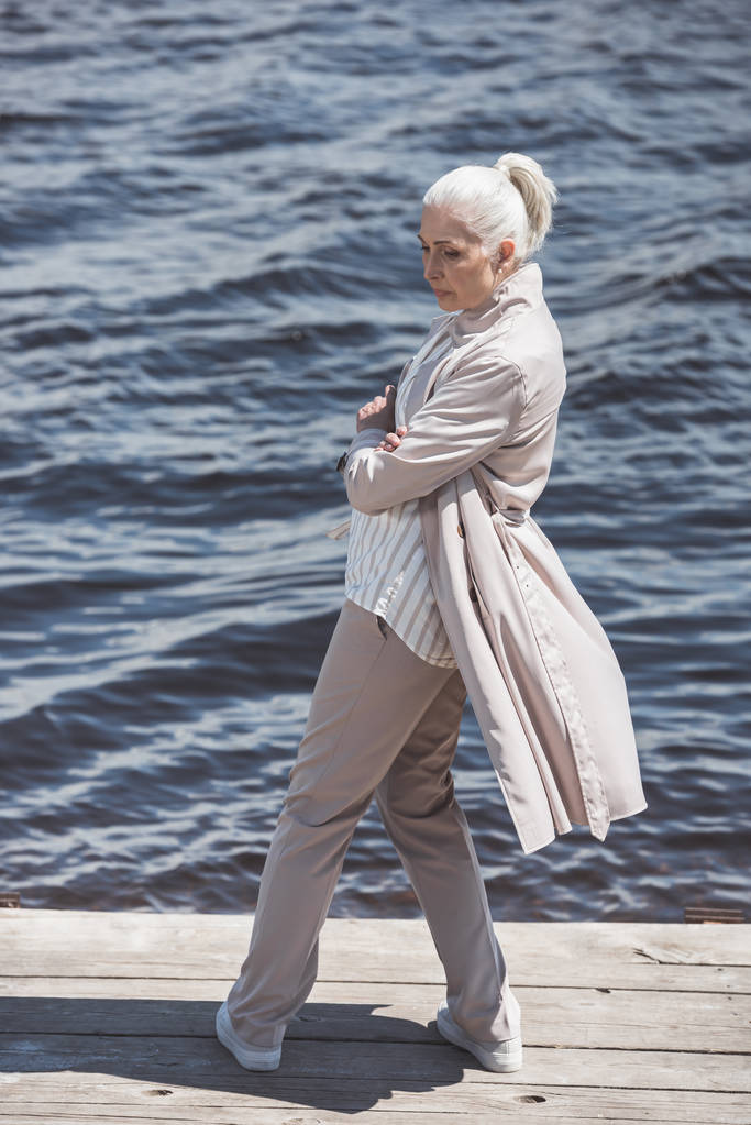 casual elderly woman posing on riverside - Photo, Image