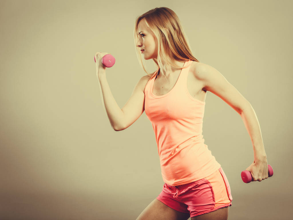 Fitness woman exercising with dumbbells. - Photo, Image