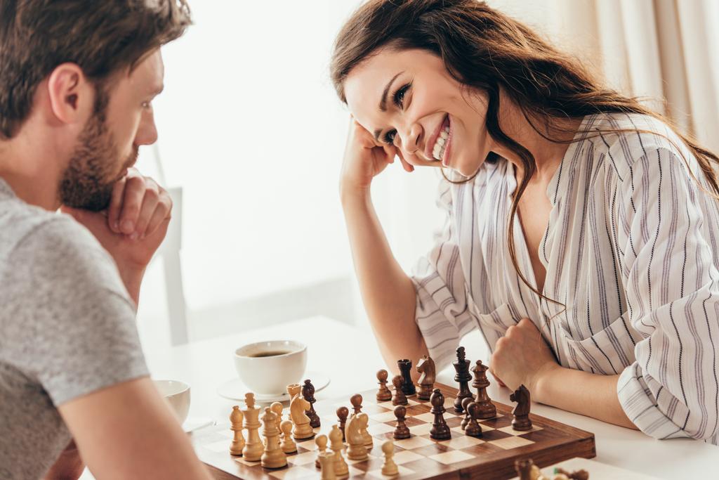 young couple playing chess at home - Photo, Image
