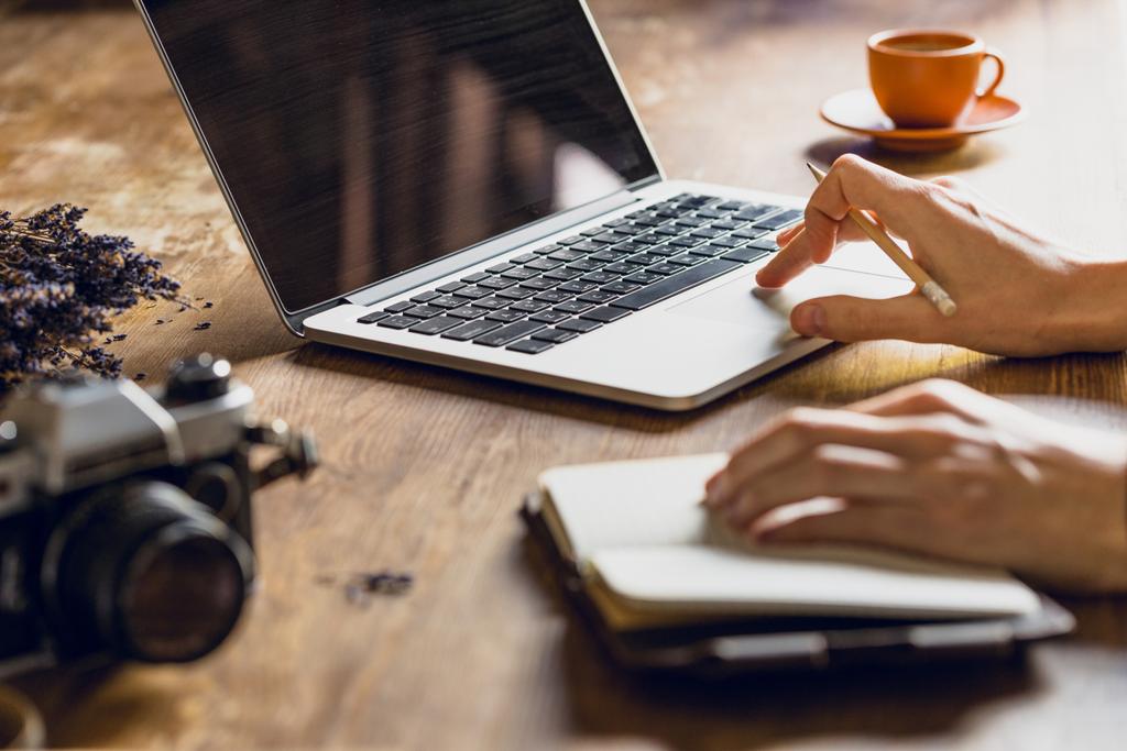 pessoa usando laptop e diário no espaço de trabalho com câmera fotográfica vintage
 - Foto, Imagem