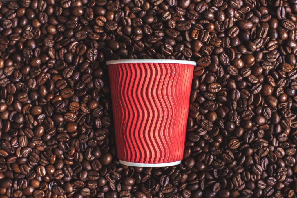 plastic cup on roasted coffee beans - Photo, Image