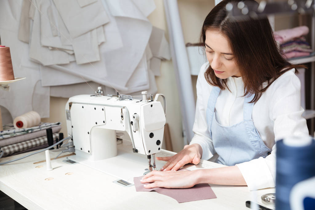 Image of seamstress working with sewing machine - Photo, Image