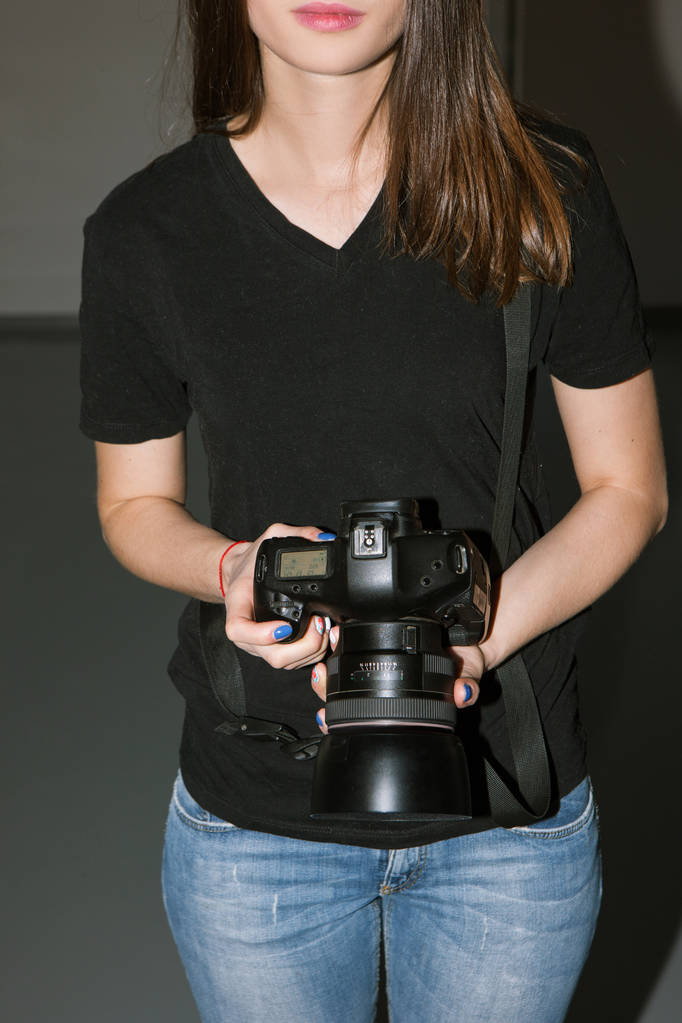 Female photographer and black camera - Photo, Image