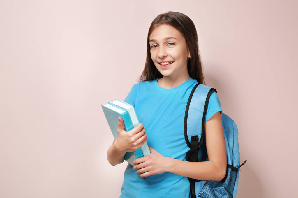 дівчина з книгами та шкільною сумкою
 - Фото, зображення