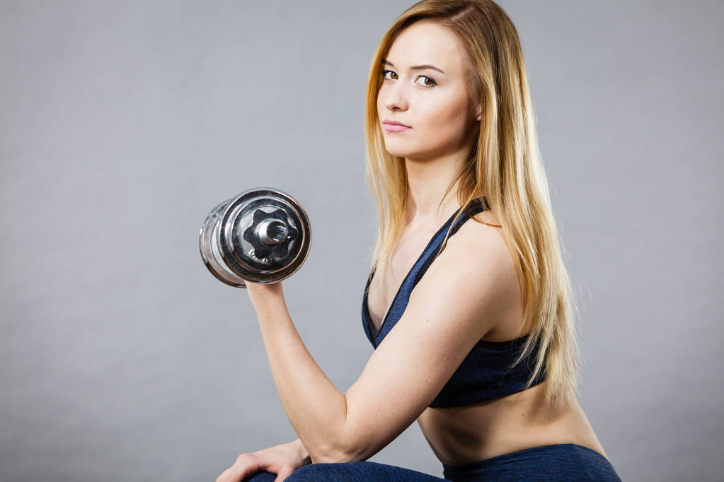 Woman working out at home with dumbbell - Photo, Image