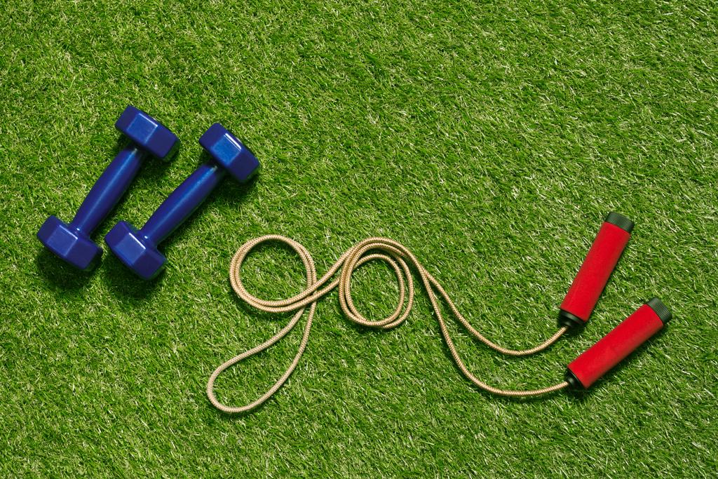 dumbbells with jump rope on grass - Photo, Image