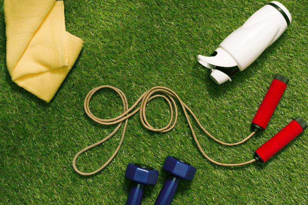 jump rope with towel and bottle on grass - Photo, Image