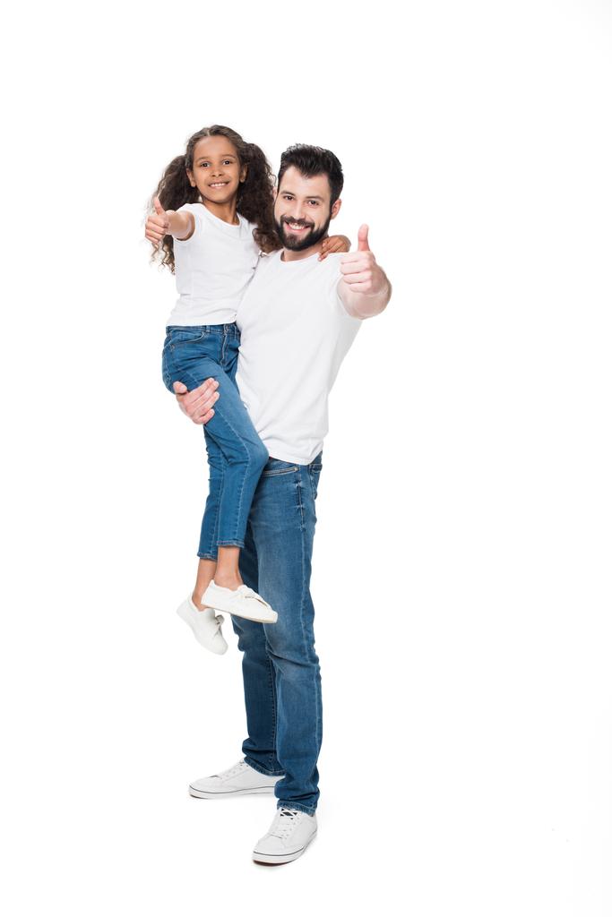 батько і дочка показують великі пальці вгору
  - Фото, зображення