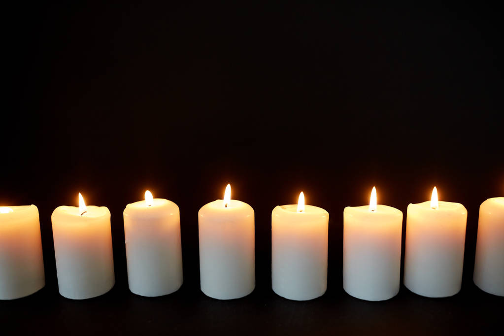candles burning in darkness over black background - Photo, Image