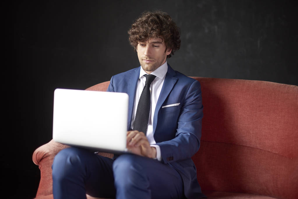 confident youn businessman with laptop  - Photo, Image