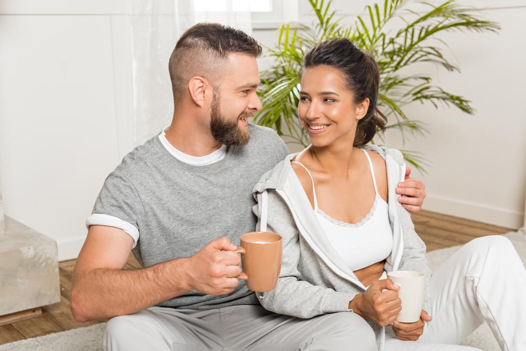 couple drinking coffee while sitting at home - Photo, Image