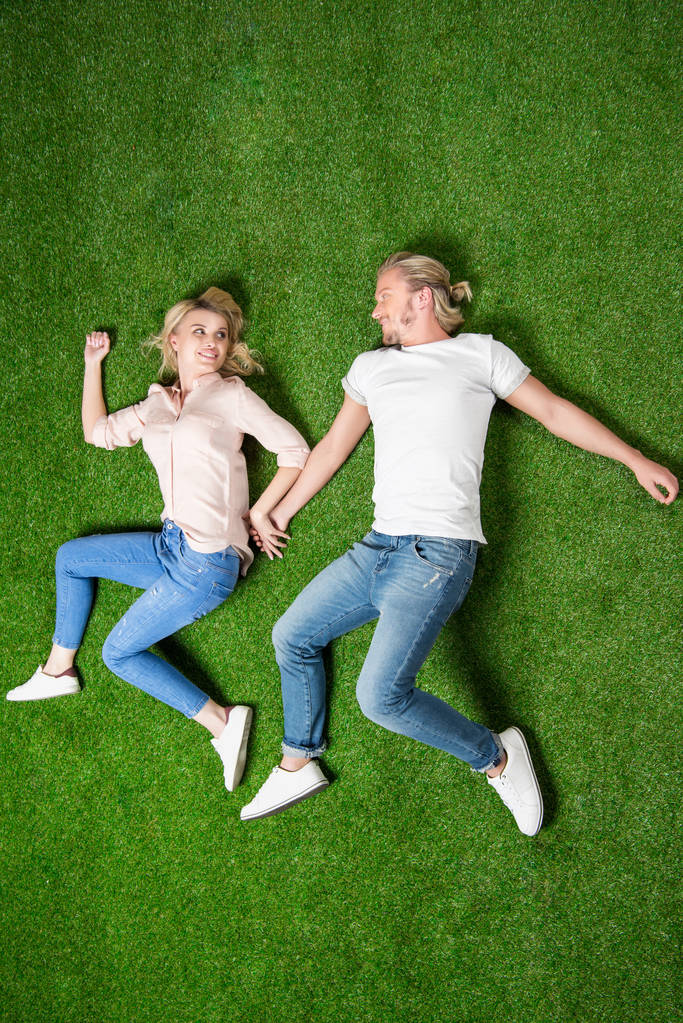 young couple lying on grass - Photo, Image