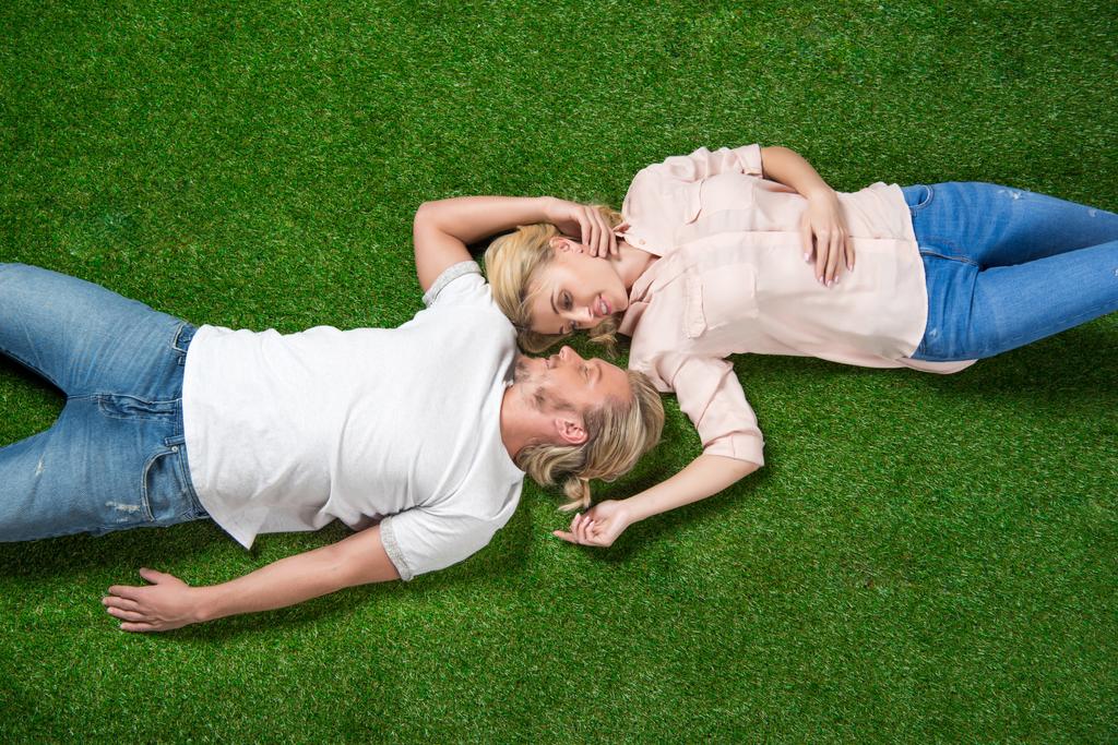 sweethearts lying on grass - Photo, Image