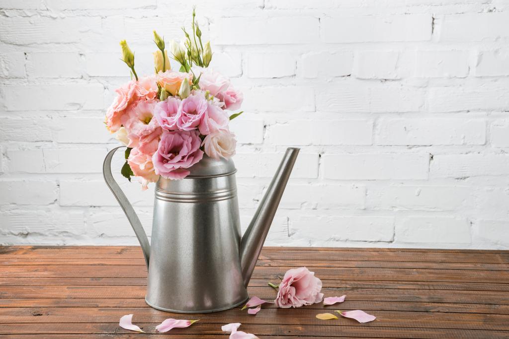 Beautiful flowers in watering can - Photo, Image
