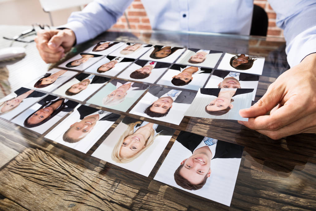 Close-up Of A Businessman Making Candidate Selection Over The Desk At Workplace - Photo, Image
