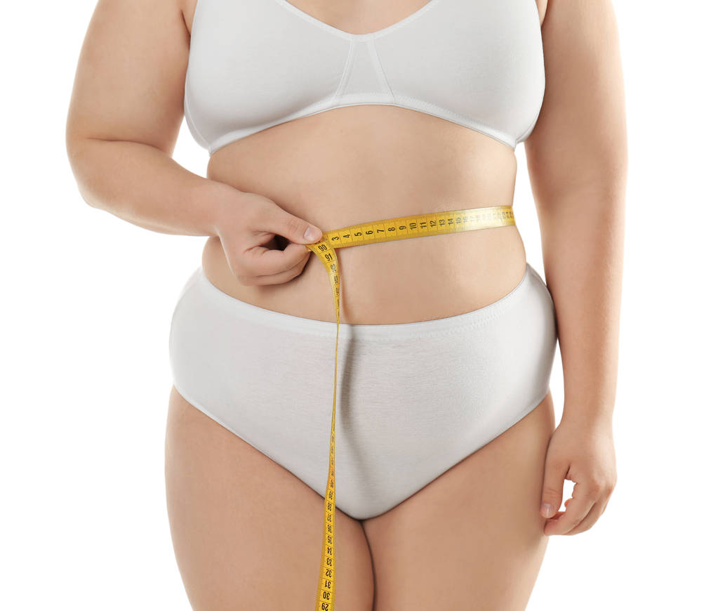 太りすぎの女性のウエストを測定 - 写真・画像