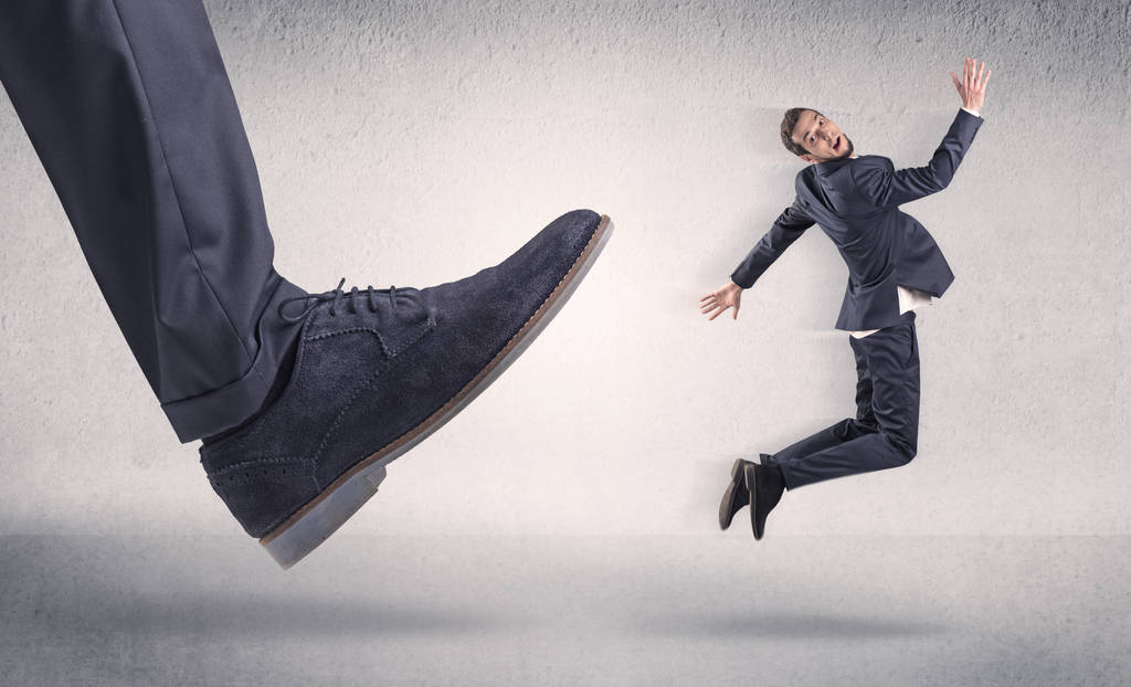 Small businessman kicked by big shoe - Photo, Image