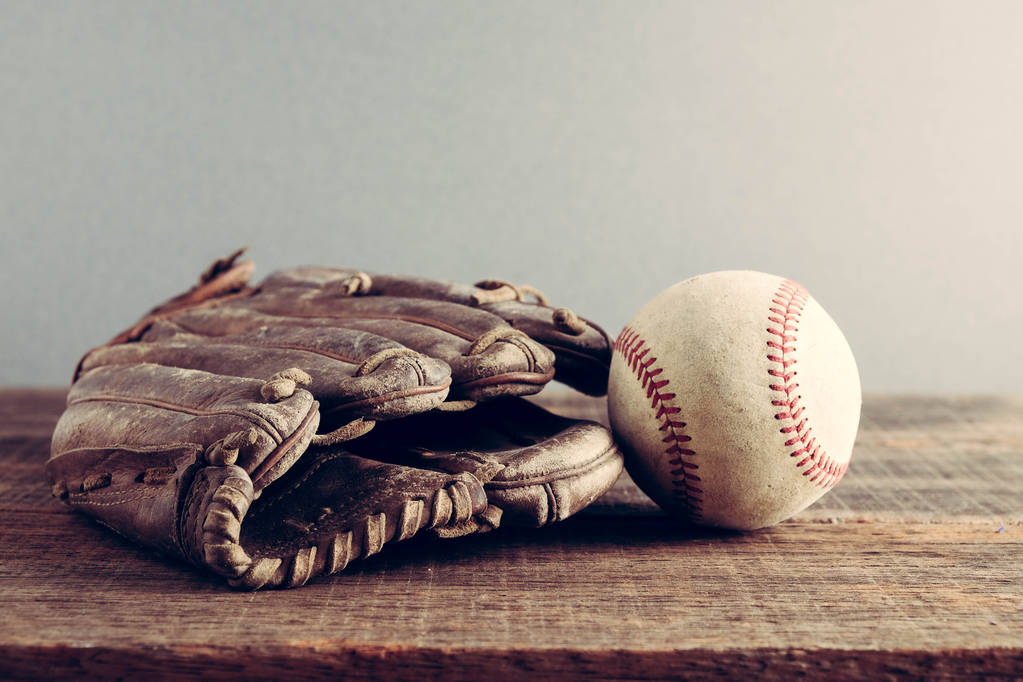 oude honkbal en handschoen op hout achtergrond met filter effect retro vintage stijl - Foto, afbeelding